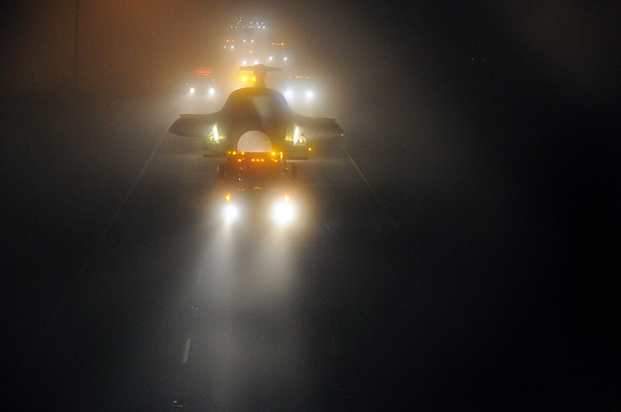 Oversize load moving at night with escort lighting